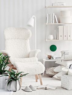 a white living room filled with lots of furniture