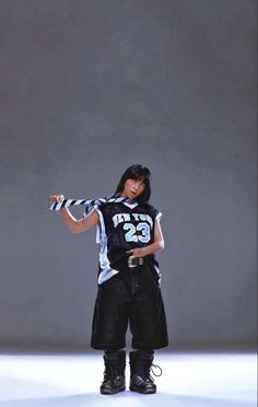 a woman in black and white striped shirt pointing at something