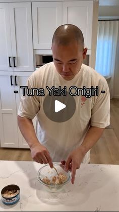 a man standing in front of a table with food on it and the words tuna yaki omei