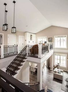 a large open floor plan with stairs leading up to the second story