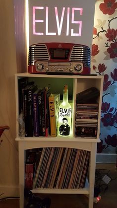 a book shelf with an elvis sign above it