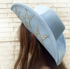 "Blue cowboy hat with stars embellished on it.  ► DETAILS - Structured glitz faux suede hat - Interior cinch tie band - 3 1/2\" brim One size fits most. Adjustable sizing ► CARE INSTRUCTIONS Spot clean only. ► PROCESSING TIME: Please check listing for the current processing time - Orders usually ship within 3 business days  - Please allow approximately 2-5 days for arrival after shipping - Please TRIPLE check your address. Please make sure that your saved address on Etsy is your current address because we will ship your order by default to your saved address. We are not responsible for items going to the wrong address.  *If you entered the wrong address, please contact us right away. Addresses cannot be changed once the order is shipped. ► RETURNS AND EXCHANGES Since all of our products ar Glow Cowgirl Hat, Luxury Rhinestone Cowboy Hat For Party, Luxury Blue Hat For Festivals, Western Hats Concert, Luxury Rhinestone Cowboy Hat, Shooting Star Hat, Rine Stone Cowgirl Hat, Glow In The Dark Cowgirl Hats, Cowboy Bachelorette Party Hats