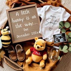 a winnie the pooh baby shower gift basket with personalized items, including a t - shirt and shoes