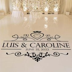 the floor is decorated with white flowers and black lettering that says, louis & caroline