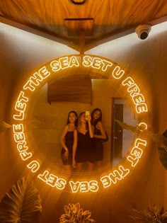 two women are sitting in front of a mirror with the words, the sea set on it