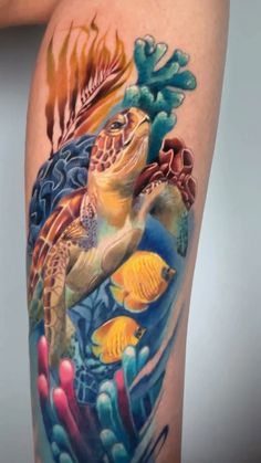 a tattoo with an image of a sea turtle and corals