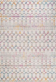 a white rug with multicolored geometric designs on the front and back sides,