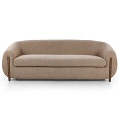 a beige couch sitting on top of a white floor