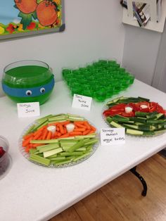 there are many vegetables on the table with name tags in front of them, including carrots and celery