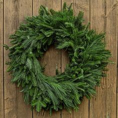 a wreath is hanging on the side of a wooden wall