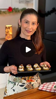 a woman holding a tray with food on it