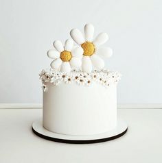 a white cake with flowers on top