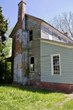 an old run down house sitting in the grass