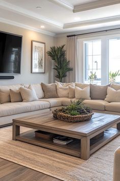 a living room filled with lots of furniture and a flat screen tv mounted on the wall