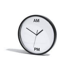 a white clock with black hands and the words am pm on it's face