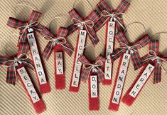 four red and white tags with words on them hanging from twine ribbons that spell out the names of five different languages