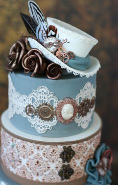 a three tiered cake decorated with lace and flowers