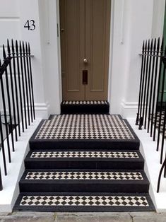 black and white tiled steps leading up to a door