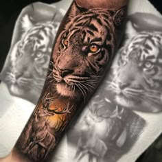 a man with a tiger and deer tattoo on his arm