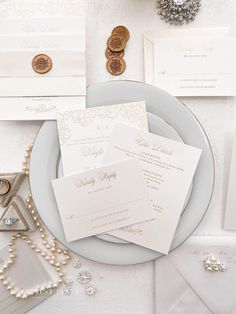 the wedding stationery is laid out on a plate