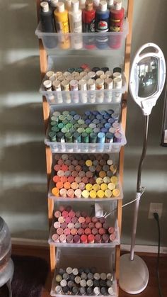 a shelf filled with lots of different colored paints