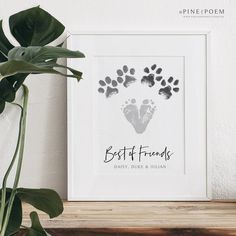 a white framed print with the words best friends and an image of a baby's handprint