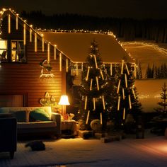 a living room with christmas lights on the wall and couches in front of it