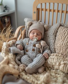 a baby sleeping in a crocheted bed with a stuffed animal