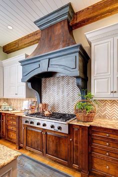 a kitchen with an oven, stove and cabinets in the middle of it is surrounded by wood flooring