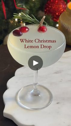 a white christmas lemon drop cocktail sitting on top of a table