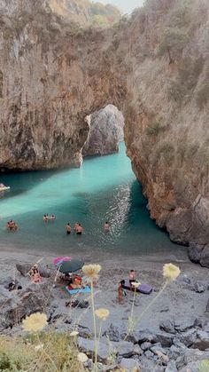 people are swimming in the blue lagoon at low tide