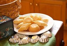 some cookies are sitting on a plate next to a basket and other items in front of it