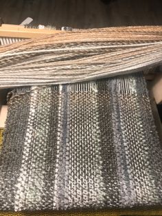 the weaving is being worked on by someone who has already finished their weaving project and it looks like they are going to be done