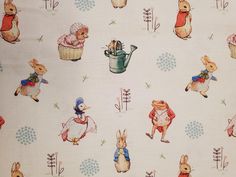 the fabric has rabbits and flowers on it