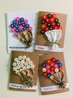 four different types of flowers are displayed on brown cards with white and green ribbons tied to them