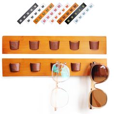 a wooden shelf with sunglasses, cup holders and other items on it's side