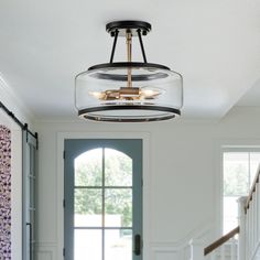 a light fixture hanging from the ceiling in a hallway