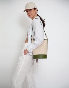 An iconic, leather-trimmed, cotton linen canvas bucket bag • Shoulder Strap Drop: 26- 29"• Crossbody Strap Drop: 40"-47"• Height: 11"• Width: 8"• Depth: 8" • 60% cotton/ 40% linen with 100% genuine leather trim• fully lined• magnetic snap closure• interior zip pocket• adjustable, removable shoulder strap• extra crossbody strap• spot clean Designer Cream Bucket Bag, Designer Coated Canvas Bucket Bag, Luxury Green Canvas Shoulder Bag, Designer Bucket Bag For Errands, Designer Everyday Bucket Bag, Luxury Summer Shoulder Bag For Everyday, Luxury Everyday Summer Shoulder Bag, Leather Trim Bucket Bag For Shopping, Bucket Bag With Leather Trim For Shopping