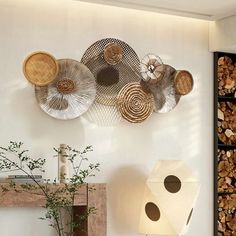 the wall is filled with different types of baskets and wood slices on it's sides