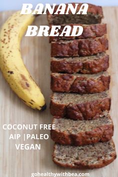 a banana bread cut into slices sitting on top of a cutting board next to a ripe banana