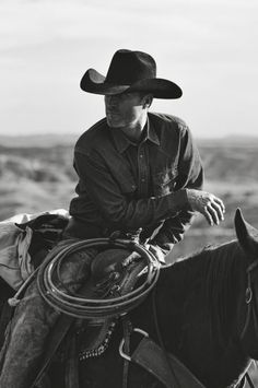 a man riding on the back of a black horse