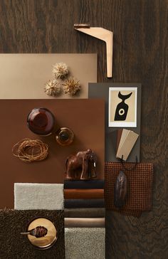 an assortment of items displayed on top of a wooden table with brown and beige colors