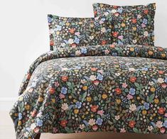 an image of a bed set with flowers on the comforter and pillowcases