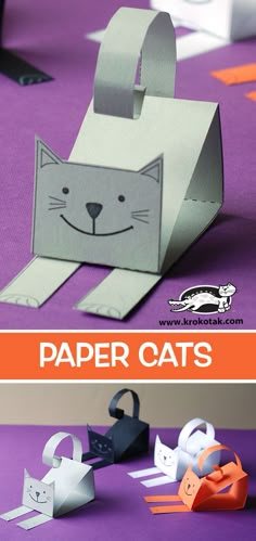 paper cats made out of toilet paper on a purple table with orange and white stripes