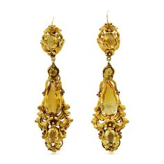 Pear shape and oval amethysts totaling approximately 24 carats are accented with cannetille floral and scroll motif settings mounted in 18 karat yellow gold. 18th Century Jewelry Earrings, Formal Baroque Yellow Gold Earrings, Formal Yellow Gold Baroque Earrings, Ornate Yellow Gold Oval Earrings, Formal Yellow Earrings With 17 Jewels, Opulent Gold Earrings For Formal Occasions, Yellow Earrings With 17 Jewels For Formal Occasions, Ginny Earrings, Ancient Earrings