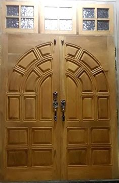 two wooden doors with arched glass windows