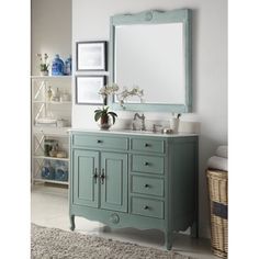 a bathroom with a blue vanity and mirror