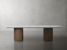 a white marble table sitting on top of a gray floor