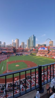 a baseball stadium filled with lots of people sitting on the bleachers looking out over the field