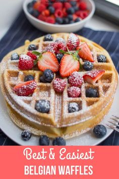 a waffle topped with strawberries and blueberries on top of a white plate